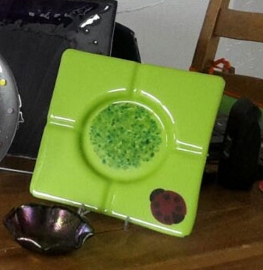 green ashtray with ladybug