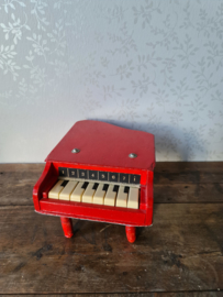 Oude rode houten kinderpiano piano