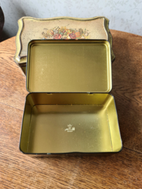 Oud zwart blikken koektrommel bloemen