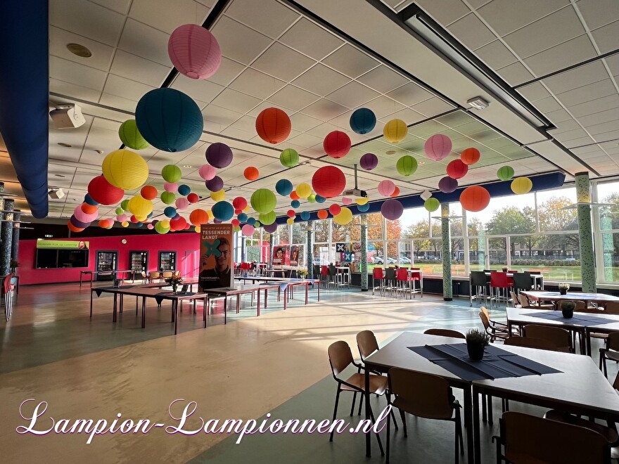 Grote bollen lampionnen in vrolijke kleuren in aula van school versiering ballon