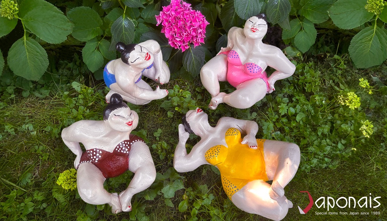 Japanese Suma's ( humorous sculptures) laying in the grass