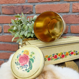 Vintage beschuitblik en ontbijtkoekblik met bloemen op craquelé achtergrond