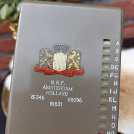 Vintage metalen adressen flip over/ index 'N.R.F. Amsterdam Holland'