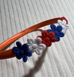 Haarband knaloranje met rood wit blauwe bloemetjes