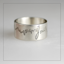 Ring extra breed zilver met hartslag en handgeschreven naam