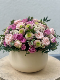 bloemstuk in stenen cache-pot crème