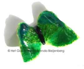 Vrolijke vlinder in grasgroene kleuren