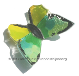 Glazen vlinder in abstract groene kleuren