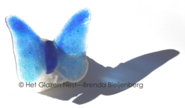 Kleine blauwe vlinder op ruw bergkristal
