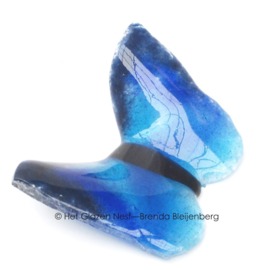 Blauwe vlinder in lichtdoorlatend glas