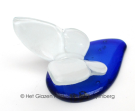 Witte vlinder op blauwe druppel van glas
