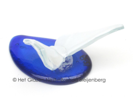 Witte vlinder op blauwe druppel van glas