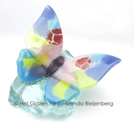 pastel kleurige vlinder op glas brok