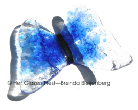 Blauwe vlinder in doorzichtig glas