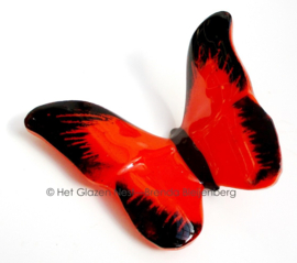 Glazen vlinder in tomaat rode kleur met zwarte randen
