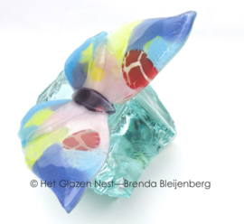 pastel kleurige vlinder op glas brok