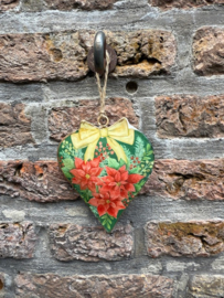 Metalen hart met Kerstster en groene achtergrond