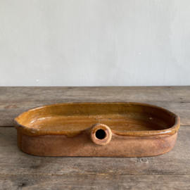 AW20111181 Antique, rustic French earthenware baking dish, unfortunately missing a piece of the bottom edge, but otherwise in beautiful condition! Size: 32.5 cm long / 5.5 cm high / 16.5 cm cross section.