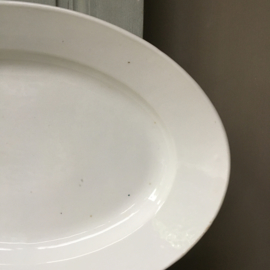 AW20110669 Large French serving dish of heavy quality porcelain. Made in Paris and in perfect condition! Size: 49.5 cm. long / 34 cm. cross section / 7 cm. high.