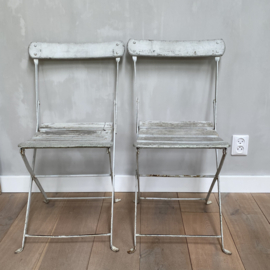 OV20110866 Set of 2 old French folding iron terrace chairs with original off-white color wooden slats seat and backrest and ... in beautiful usable condition! Size: 42.5 cm. high (to the seat) / 36 cm. wide. Pick up in my store only.