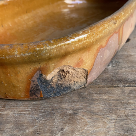 AW20111181 Antique, rustic French earthenware baking dish, unfortunately missing a piece of the bottom edge, but otherwise in beautiful condition! Size: 32.5 cm long / 5.5 cm high / 16.5 cm cross section.