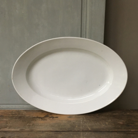 AW20110669 Large French serving dish of heavy quality porcelain. Made in Paris and in perfect condition! Size: 49.5 cm. long / 34 cm. cross section / 7 cm. high.