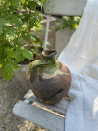 AW20110936 Antique 19th century French olive oil jug in weathered green and earthy tones. In beautiful condition! Size: 24 cm. high / 17.5 cm. cross section (over the belly)