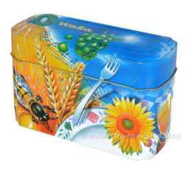 ​Orange and blue tin box for Wasa Crackers with images of a rooster, bee, sunflower, grain and fruit