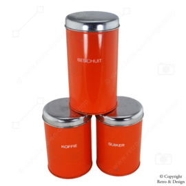 "Enchant Your Kitchen with these Vintage Brabantia Storage Canisters in Vibrant Orange"