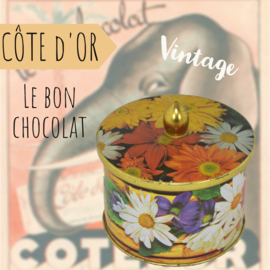 Multicoloured tin can with button and floral motifs by Côte d'Or