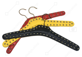 Set of three vintage Skai clothes hangers in red, yellow and black with metal nails ("studs")