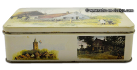 Biscuit tin with image of 'the blue house at Ouddorp' by Rien Poortvliet