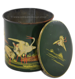 Round green vintage tin canister decorated with cranes