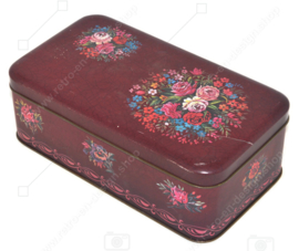 Rechteckige Vintage dunkelrote Blechdose mit mehrfarbigem Blumenmuster und Knistern