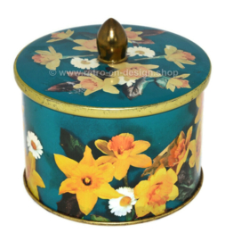 Green tin canister with knob and floral motif of daffodils and daisies by Côte d'Or