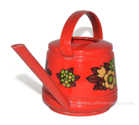 Red vintage plastic Emsa watering can with floral decoration