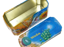 ​Orange and blue tin box for Wasa Crackers with images of a rooster, bee, sunflower, grain and fruit