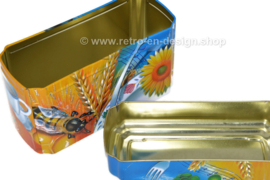 ​Orange and blue tin box for Wasa Crackers with images of a rooster, bee, sunflower, grain and fruit