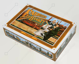 Vintage tin for Enkhuizer banquet with images of a harbour with fishing boats and regional costumes "Volendam"