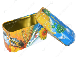 Orange and blue tin box for Wasa Crackers with images of a rooster, bee, sunflower, grain and fruit