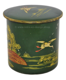 Round green vintage tin canister decorated with cranes