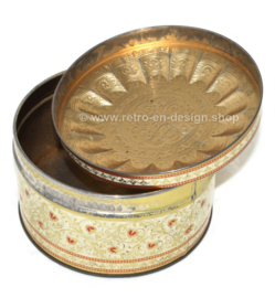 Round cream-white tin with embossed floral decoration, vintage