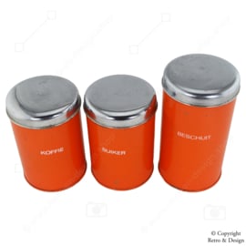 "Enchant Your Kitchen with these Vintage Brabantia Storage Canisters in Vibrant Orange"