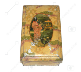 Vintage tin with image of a Japanese woman wearing a kimono