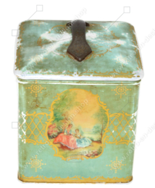 Vintage tea tin in cube shape with handle and romantic scenes