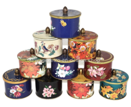 Multicoloured tin with knob and floral decor of marigolds, daisies, red clover and more by Côte d'Or