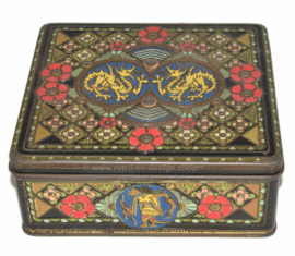 Vintage square tea tin with oriental motifs, dragons, wajang and flowers