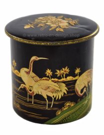 Round vintage tin canister decorated with cranes