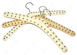 Set of three vintage Skai clothes hangers in cream white with metal studs