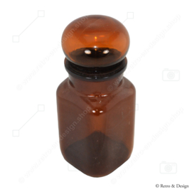 Vintage apothecary jar of brown glass. Square model with round stopper
